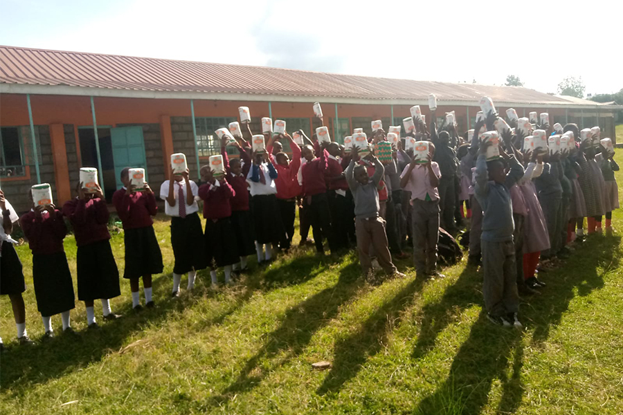 donating maize flour to school children